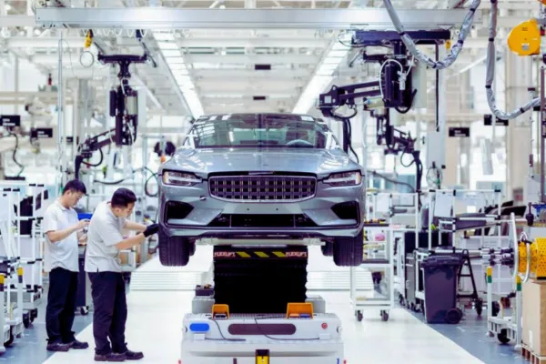 Automobile industry factory with technicians working on a car in an advanced assembly line, showcasing modern vehicle manufacturing.