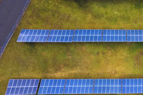 Solar panel installation in open land area, demonstrating photovoltaic industry solutions for clean energy.